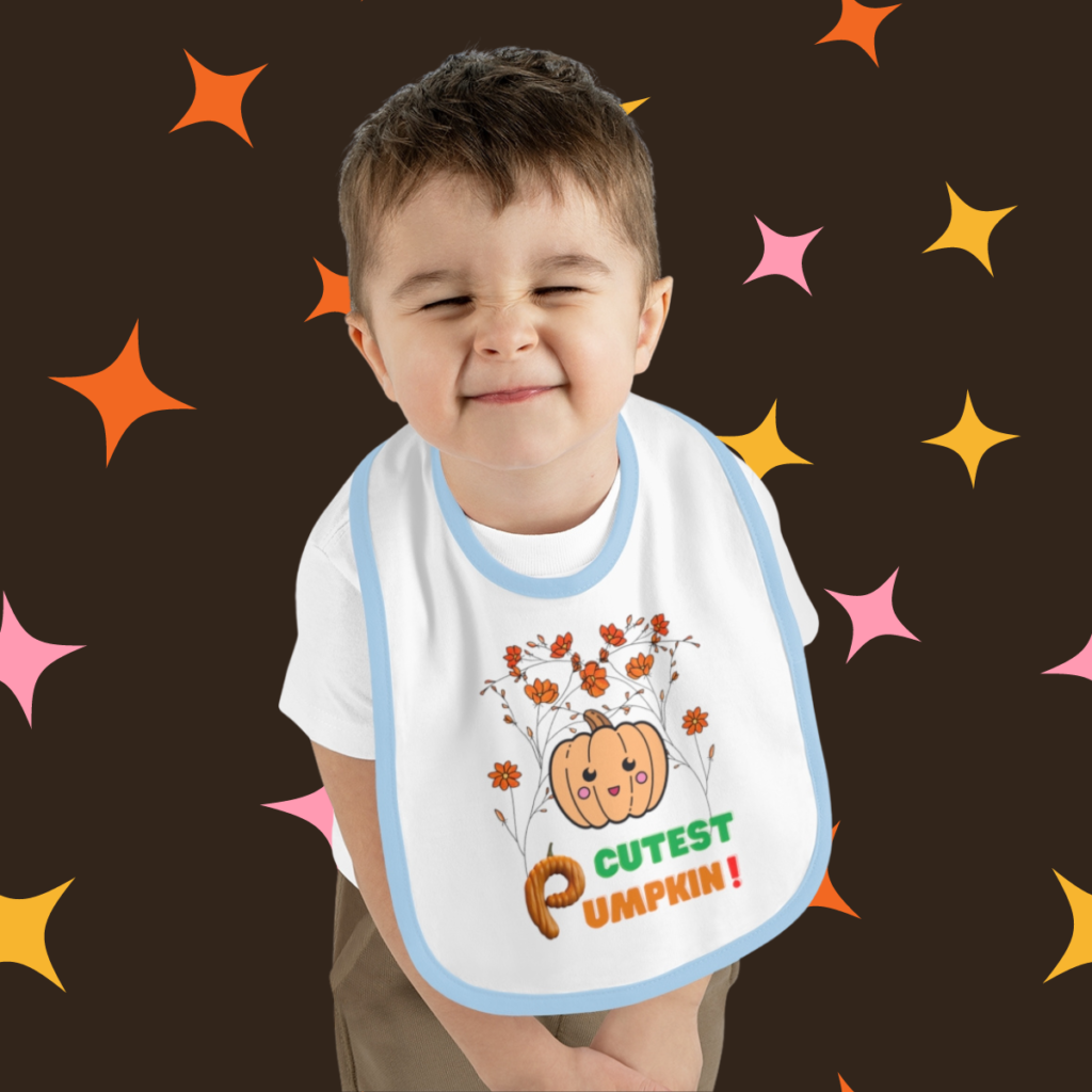Cutest Pumpkin baby bib worn by toddler featuring cute pumpkin and floral Halloween design